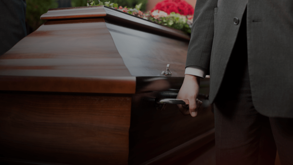 pall bearer carrying casket